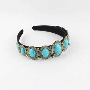 Detail of luxury wide headband with turquoise stones and blue rhinestones on black fabric