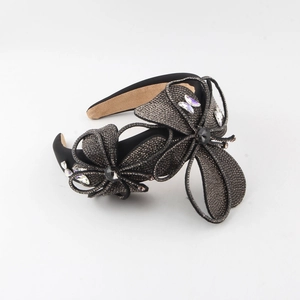 Detail showing high-quality black velvet headband with sparkling rhinestones and floral gems