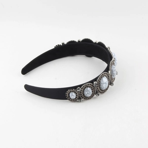 Detail of black wide headband with marble texture stones set in silver metal frames