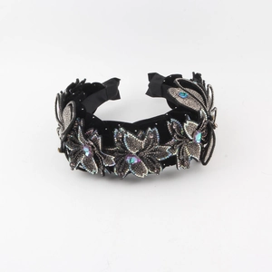 Detail of black velvet wide headband with floral embroidery and colorful crystals