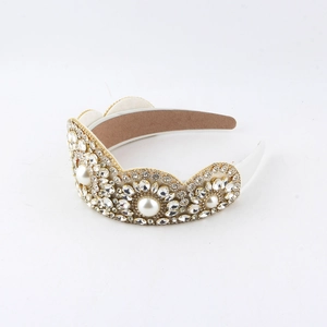 Luxurious floral headband with white pearls and sparkling crystals on a gold base