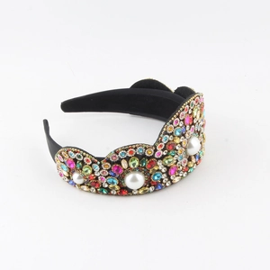 Close-up of luxury wide headband with multi-colored rhinestones and three white faux pearls