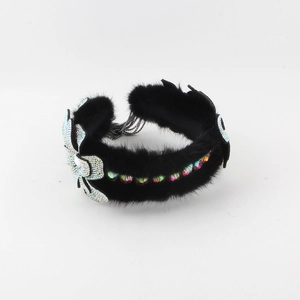Detail showing plush black mink fur headband with sparkling colorful crystal butterflies