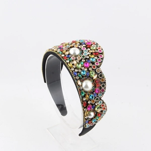 Detail of luxury wide headband featuring multi-color rhinestones and white pearls on black base