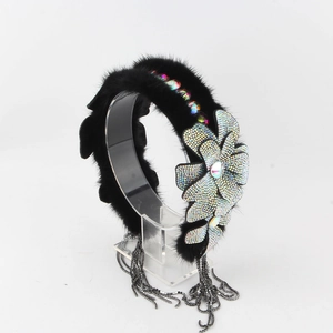 Close-up of black faux mink fur headband with iridescent rhinestone flowers and tassels