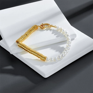 Freshwater pearl and gold textured ring bracelet with OT toggle clasp on stone display