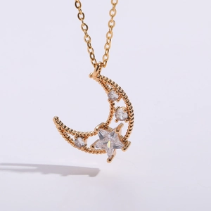Macro detail of 14K gold plated crescent moon and star pendant with sparkling zirconias
