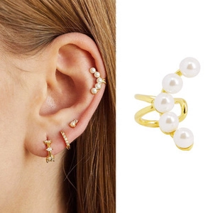 Detail view and model wearing a 14K gold plated pearl ear cuff with five white pearls