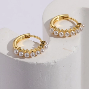 Detailed macro view of 14K gold plated hoop earrings with seven white pearls for women