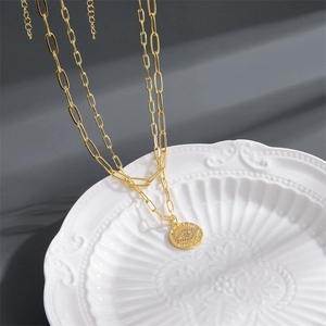 Double-layered 14K gold paperclip necklace with a pavé evil eye coin pendant