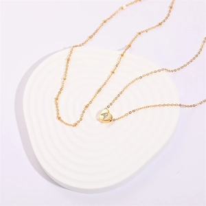 Double-layered 18K gold plated heart pendant necklace with cubic zirconia initial A detail