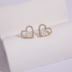 Elegant 14K gold heart stud earrings with white pearls and sparkling cubic zirconia stones