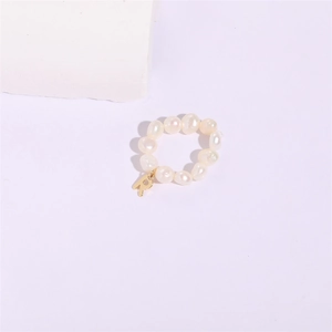 Elegant baroque pearl ring featuring a golden letter R pendant on minimalist white stone