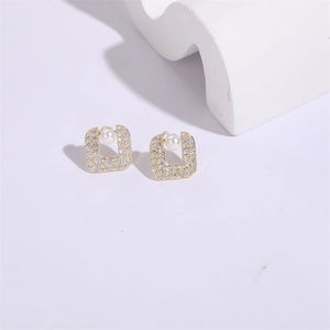 Elegant square pearl stud earrings in gold with pavé cubic zirconia on white background