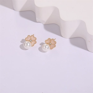 Close-up of pink enamel flower earrings with white pearls and 18K gold finish detail