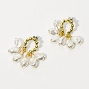 Detailed shot of 14K gold plated hoop earrings with cascading white teardrop pearls