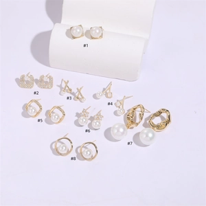 Detailed collection of eight pearl and zircon stud earrings with various geometric gold settings
