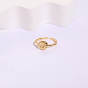 Detail shot of golden 14K twisted band ring with Love You engraved round disc