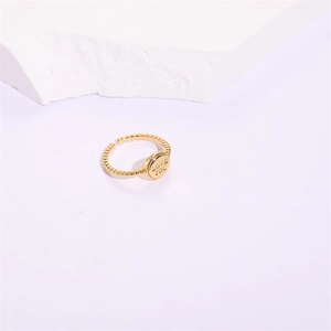 Detail of golden adjustable beaded band ring with LOVE YOU engraved on round disc