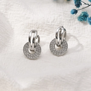 Gros plan sur les boucles d'oreilles circulaires en zircon avec placage en or 14 carats