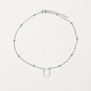 Detailed macro view of opal water drop pendant on a silver satellite choker necklace