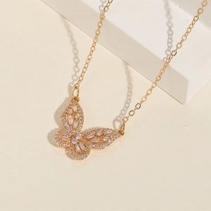 Detailed view of a 14K gold butterfly pendant necklace with sparkling zircon stones
