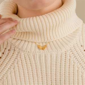 14K gold plated butterfly pendant necklace with zircon stones on knit background