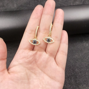 Detailed view of 14K gold plated Evil Eye drop earrings with blue and white zircon stones