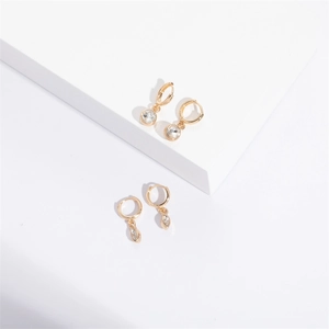 Golden geometric hoop earring set with zircon drops and marquise pendants on white display