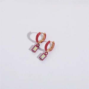 Macro shot of red enamel geometric earrings with iridescent rectangular zircon charms
