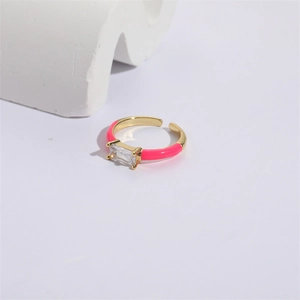 Detail of square zircon ring with bright pink enamel finish on 14K gold band