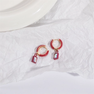 Geometric red enamel hoop earrings with colorful iridescent rectangular charms on white background