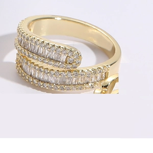 Detailed macro view of layered gold ring featuring baguette cut and round cubic zirconia