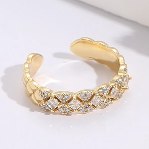 Detail of 14K gold open ring featuring a crisscross zircon lattice and wavy edge design