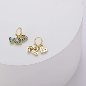 Detailed macro view of 14K gold-plated heart earrings with sky blue zircon inlay