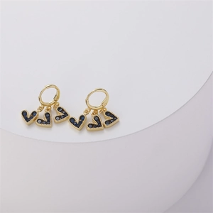 Detail of 14K gold heart drop earrings with navy blue zircon pave setting charms