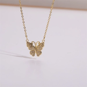 Close-up of 14K gold plated butterfly pendant with micro-set cubic zirconia stones