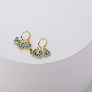Detailed close-up of 14K gold-plated heart earrings with blue micro-bead inlay details
