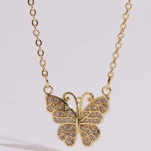 Detailed close-up of butterfly pendant with pavé set cubic zirconia and gold chain