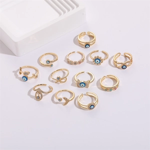 Detailed view of 12-piece evil eye gold ring set with blue enamel and zircon stones
