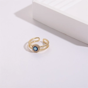 Macro shot of evil eye ring detail with blue enamel, zircon pave and double-layer band