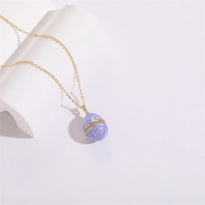 Vintage 14K gold plated Faberge style purple enamel egg necklace with white zircon accents