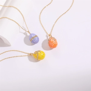 Three gold necklaces with purple orange and yellow marble enamel egg pendants with zircon