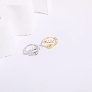 Detailed view of evil eye adjustable rings in gold and silver finish with crystal inlay