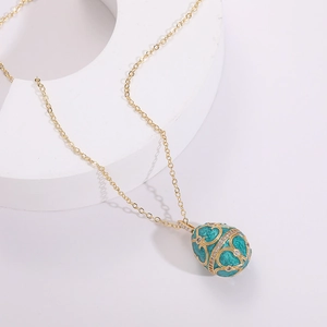 Green enamel egg pendant necklace with gold wirework and 14K gold-plated chain