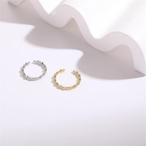 Detail of minimalist adjustable rings with zircons in gold and silver plating