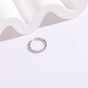 Minimalist silver geometric bubble ring with zircon stones on white abstract background