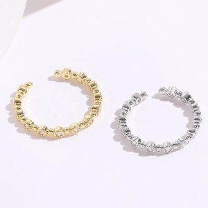Close-up of gold and silver open rings featuring micro-pave round zircon settings