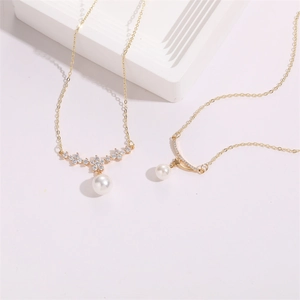 Elegant gold necklaces with flower pendants, zircon accents, and pearls on white pedestals