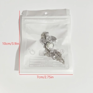 Detailed size measurement of a glowing dragon pendant necklace in its packaging
